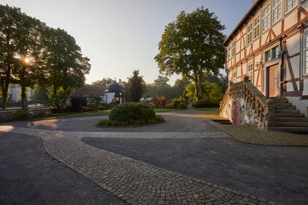 Een charmant vakwerkhuis in Borchen, omgeven door de natuur en badend in zacht zonlicht.